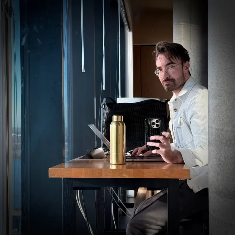 Henrik working at a laptop by a window
